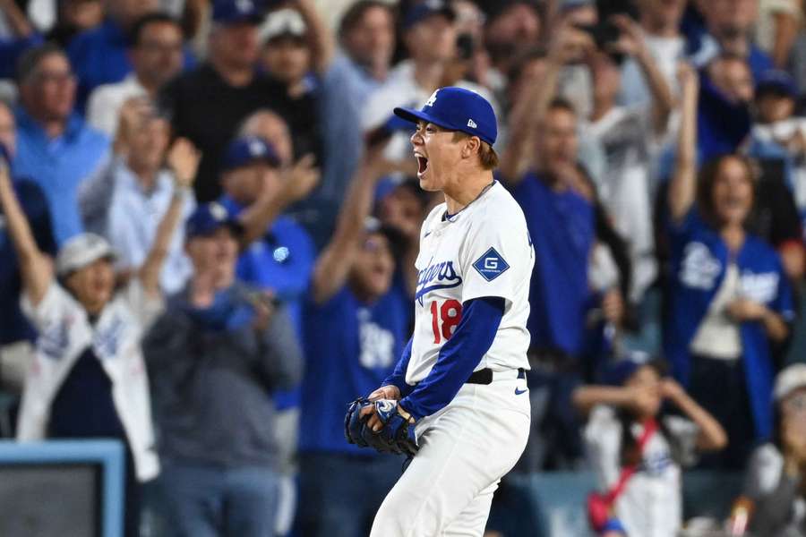 Dodgers starting pitcher Yoshinobu Yamamoto reacts after a clutch 6th inning during Game 2 of the NL Wild Card Series