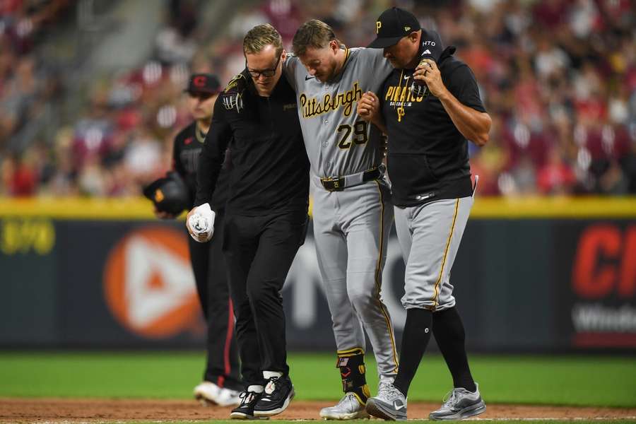 Pirates' Ryan O'Hearn being helped off the field with a leg injury Pirates' Ryan O'Hearn being helped off the field with a leg injury