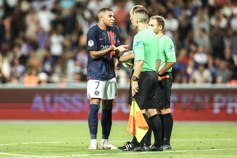 Paris Saint-Germain's French forward #07 Kylian Mbappe talks with referees