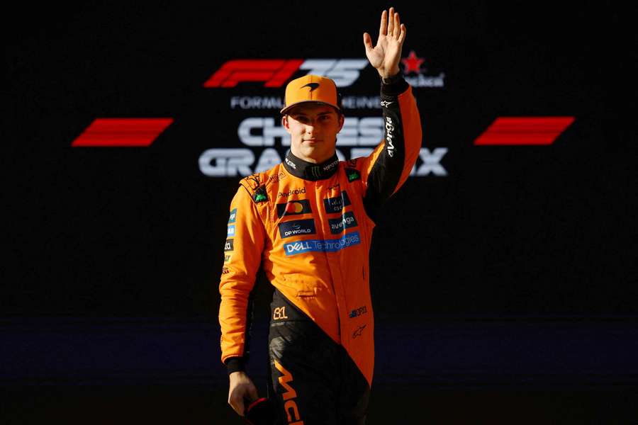 Oscar Piastri salutes the crowd after securing pole position