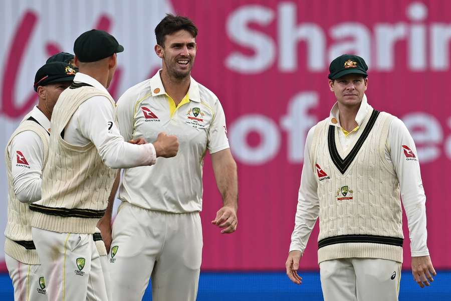 Australia's Mitchell Marsh (C) celebrates with teammates after taking the wicket of England's Zak Crawley on day one of the third Ashes cricket Test