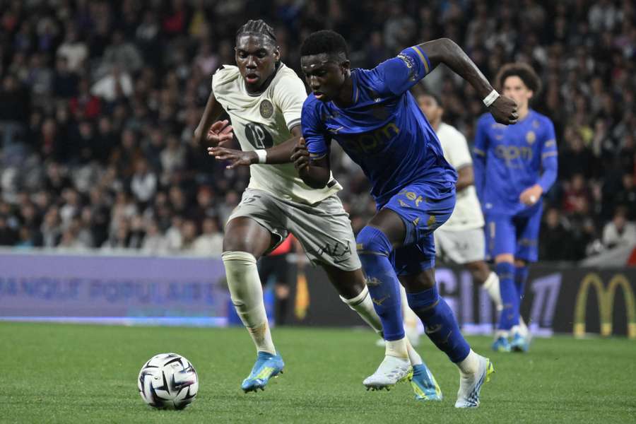 Toulouse's Alexis Vossah and Monaco's Lamine Camara fight for the ball