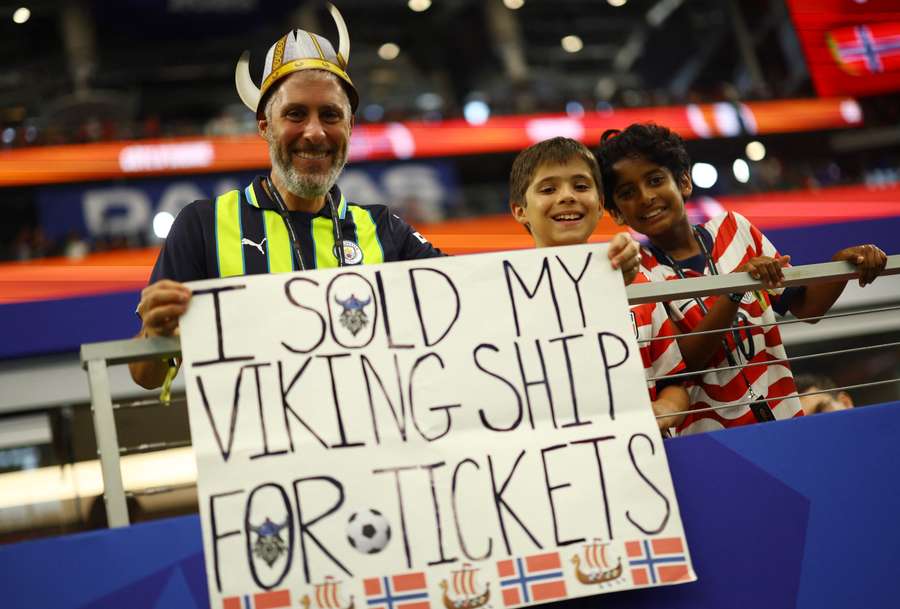 A Norway fan holds a sign inside the stadium before the match