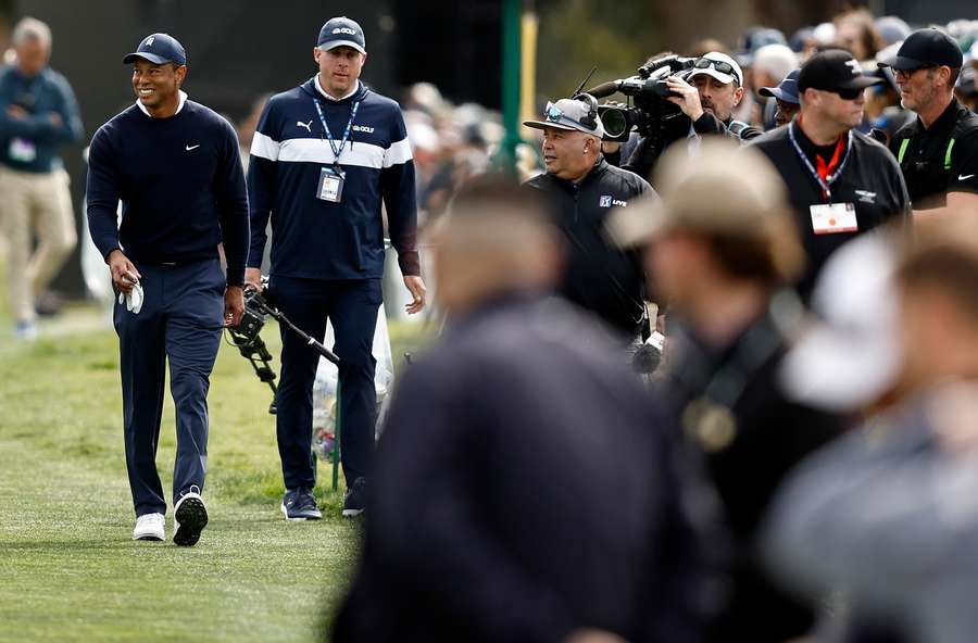 Tiger Woods walks to the first tee on Thursday