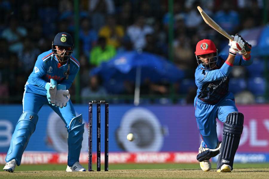 Afghanistan's Azmatullah Omarzai (R) plays a shot as India wicketkeeper KL Rahul watches