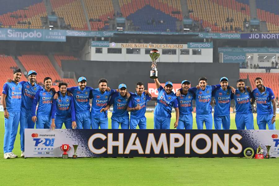 India's players celebrate their win with the trophy