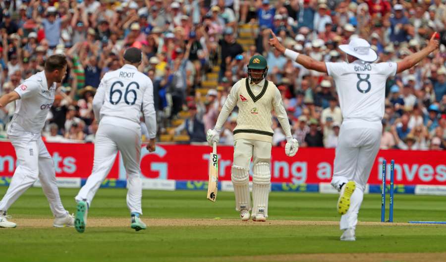 Australia's Usman Khawaja (C) reacts after he is bowled by England's Ollie Robinson (L) on day three of the first Ashes cricket Test