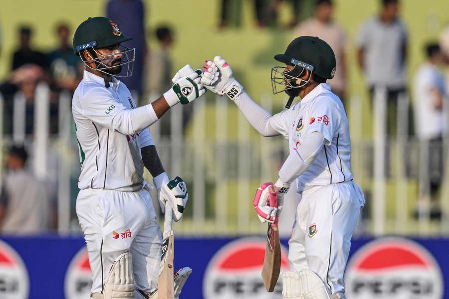 Bangladesh's Litton Das and Mushfiqur Rahim, right, bump their fists