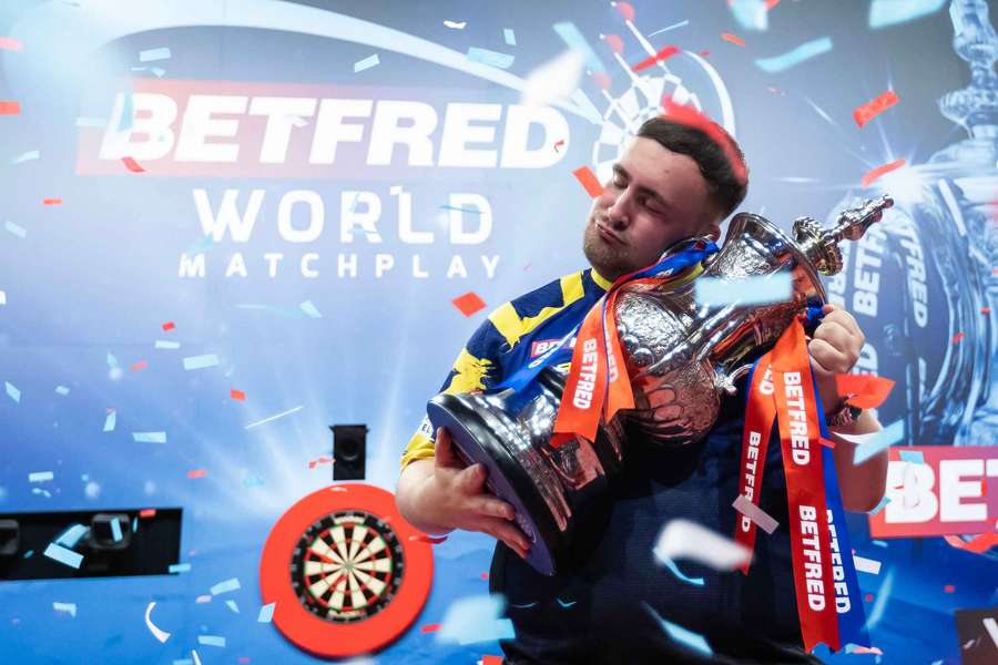 Luke Littler celebrates with the trophy after winning the 2025 World Matchplay Luke Littler celebrates with the trophy after winning the 2025 World Matchplay