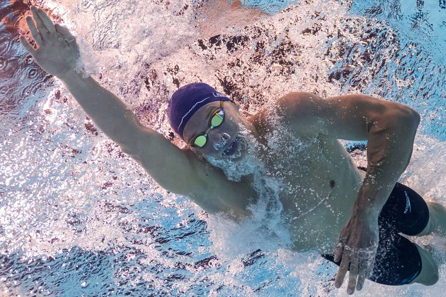 An underwater view shows France's Leon Marchand competing in the final of the men's 400m individual medley