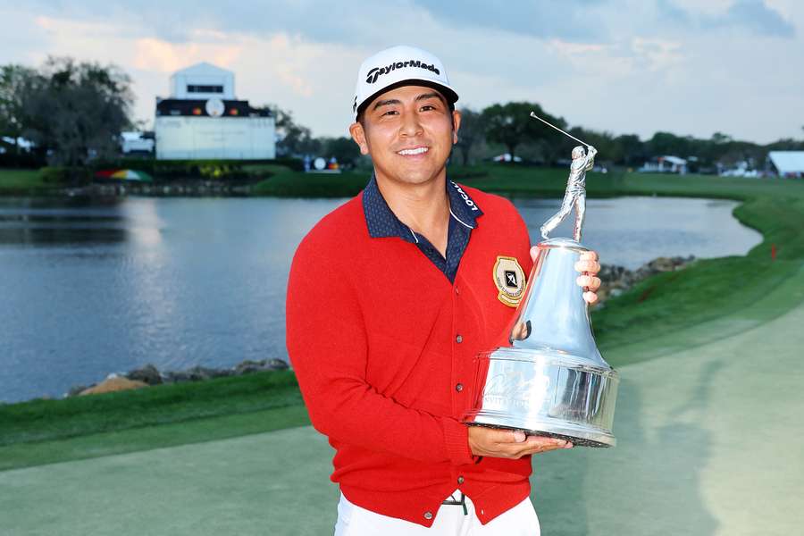 Kurt Kitayama of the United States poses with the trophy