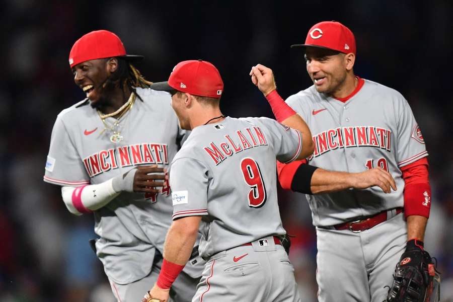 Cincinnati Reds third baseman Elly De La Cruz, shortstop Matt McLain and first baseman Joey Votto celebrate their victory over the Chicago Cubs