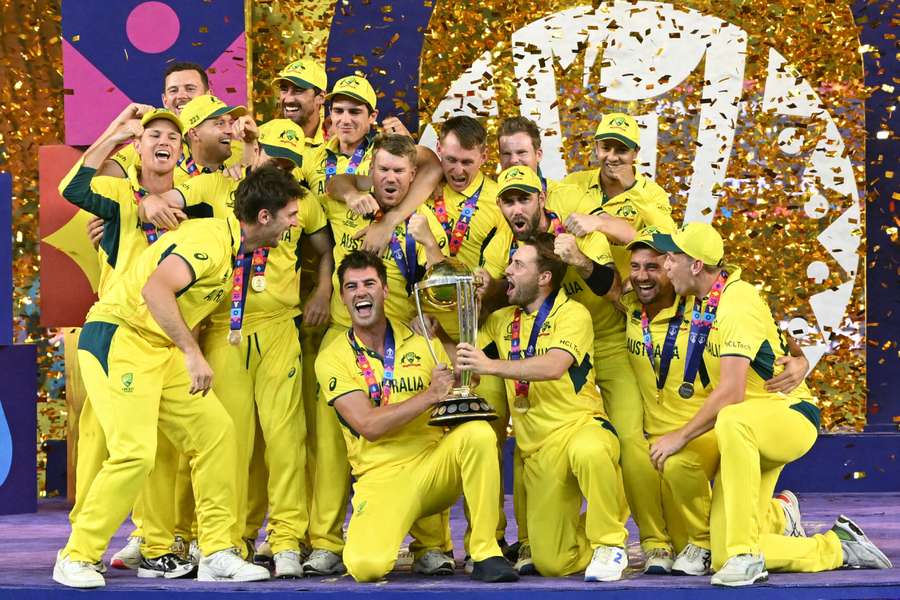 Australia celebrate with the World Cup trophy after beating India in the final