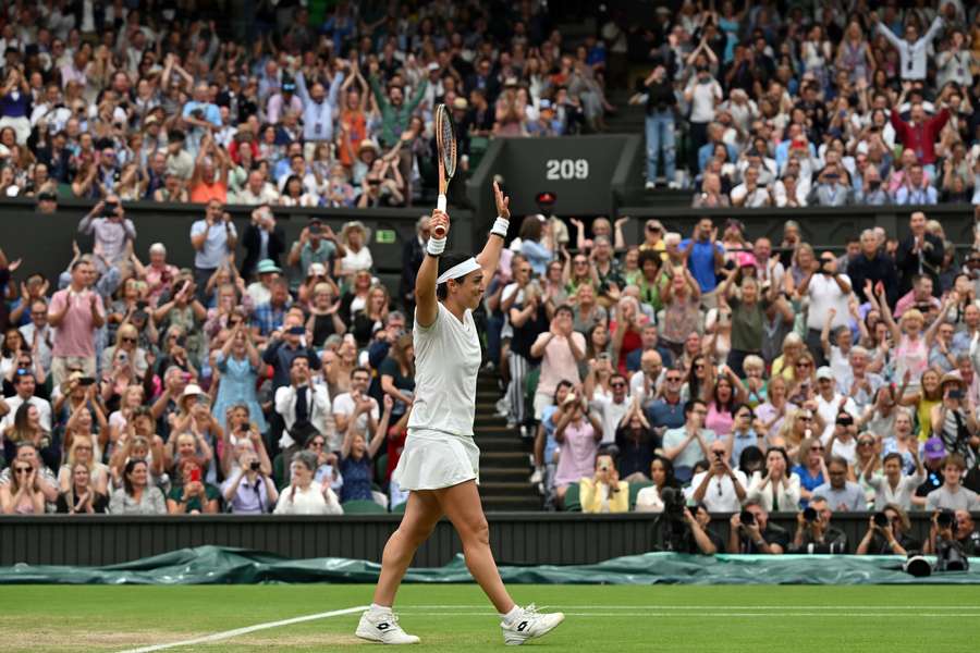 Ons Jabeur reacts after beating Aryna Sabalenka to reach the Wimbledon final