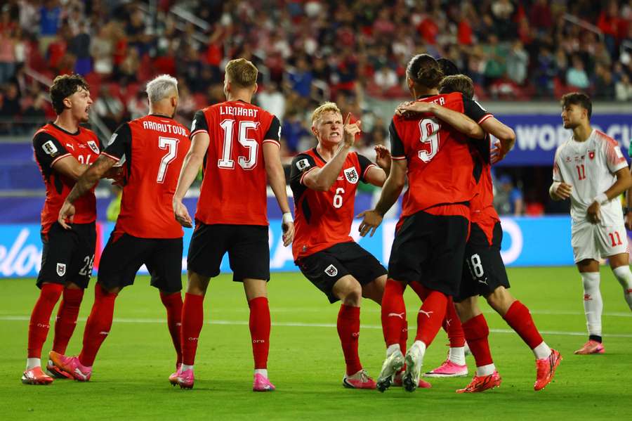 Austria's players celebrate against Jordan
