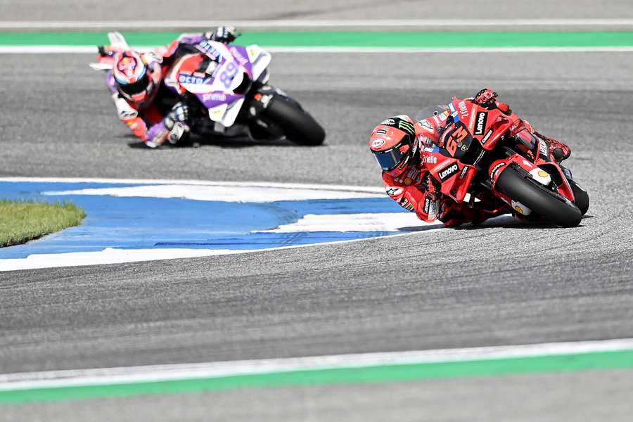 Bagnaia (R) makes his way around a tight corner during qualifying