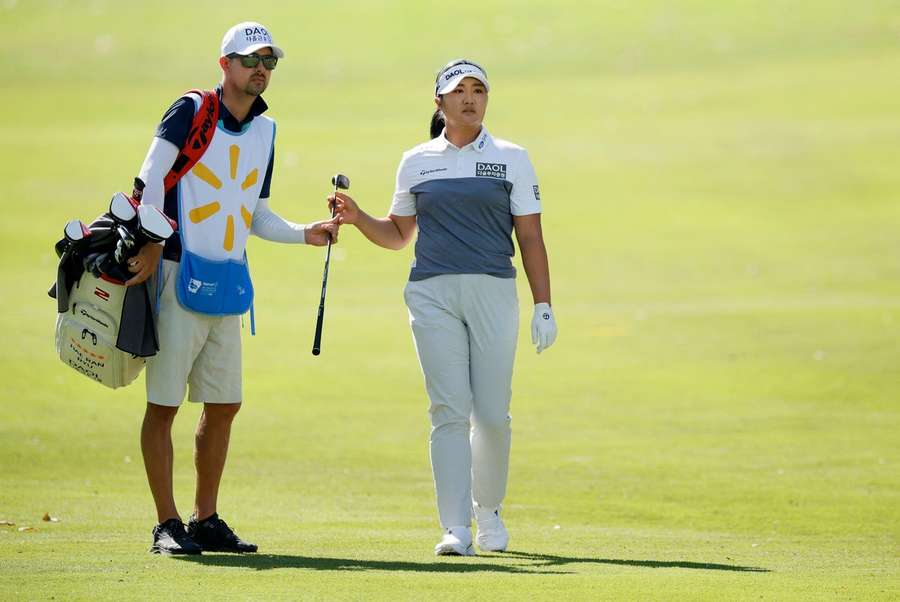 Ryu, right, alongside her caddy