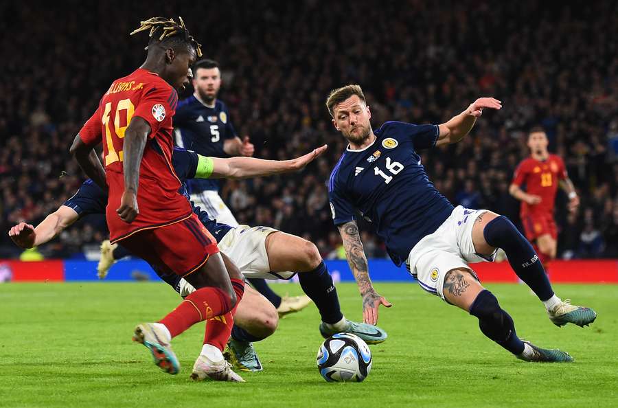 Scotland's defender Liam Cooper vies with Spain's midfielder Nico Williams