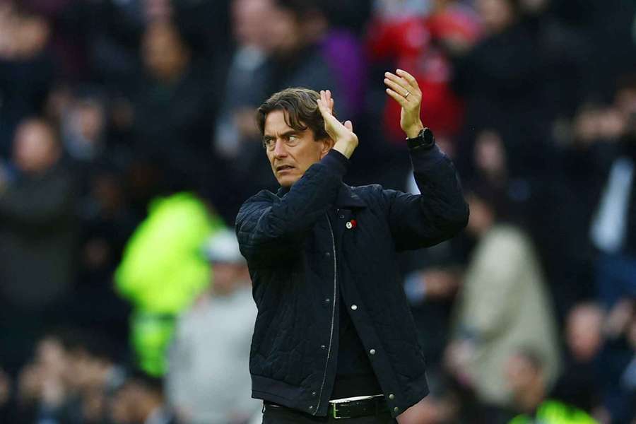 Tottenham Hotspur manager Thomas Frank applauds the fans