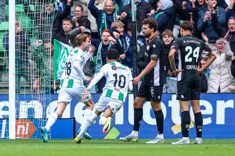 FC Groningen celebrate Tygo Land's 2-0 against NEC while Philippe Sandler and Deveron Fonville (R) sulk FC Groningen celebrate Tygo Land's 2-0 against NEC while Philippe Sandler and Deveron Fonville (R) sulk