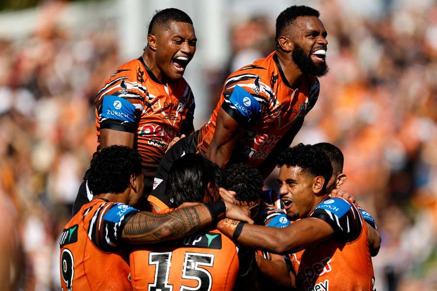 Jarome Luai and his Wests Tigers teammates celebrate a try scored against the Cowboys. Jarome Luai and his Wests Tigers teammates celebrate a try scored against the Cowboys.