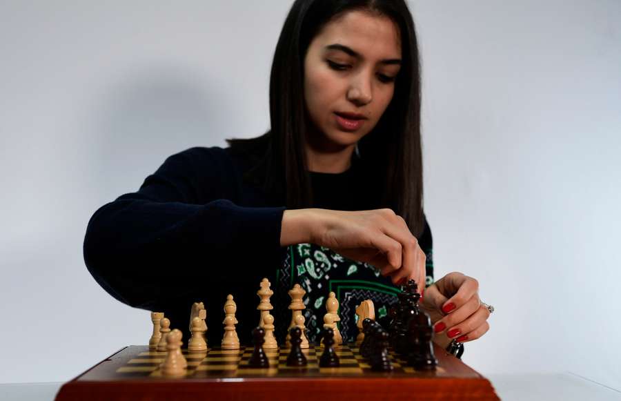 Iranian chess champion Sara Khadem poses for a photograph playing chess in the south of Spain