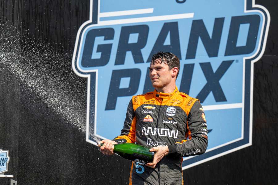 Pato O'Ward celebrates on the IndyCar podium