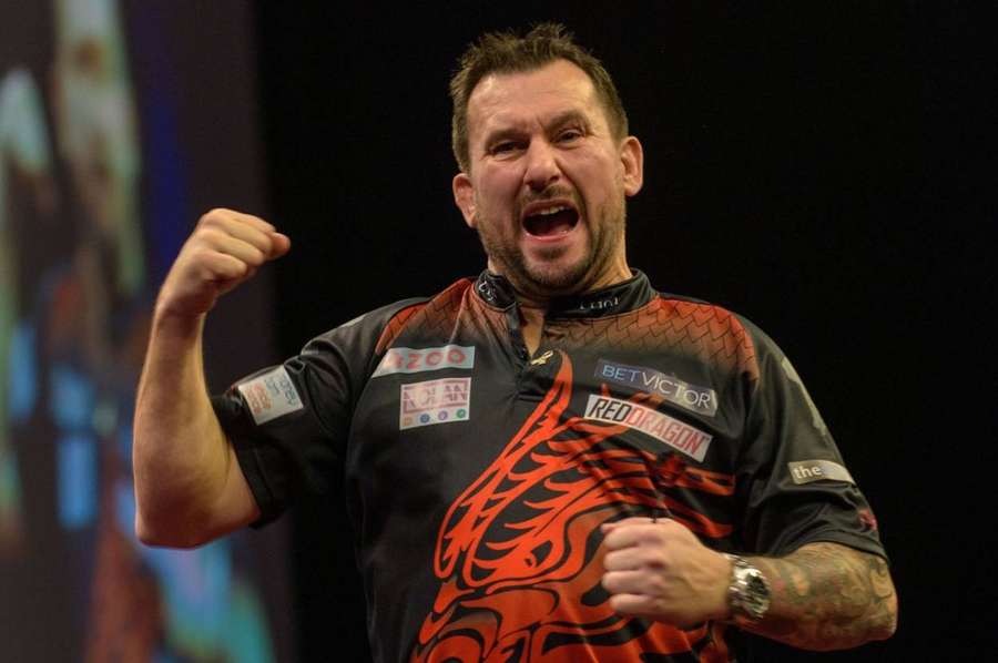 Jonny Clayton celebrates beating Peter Wright to win back-to-back Premier League finals