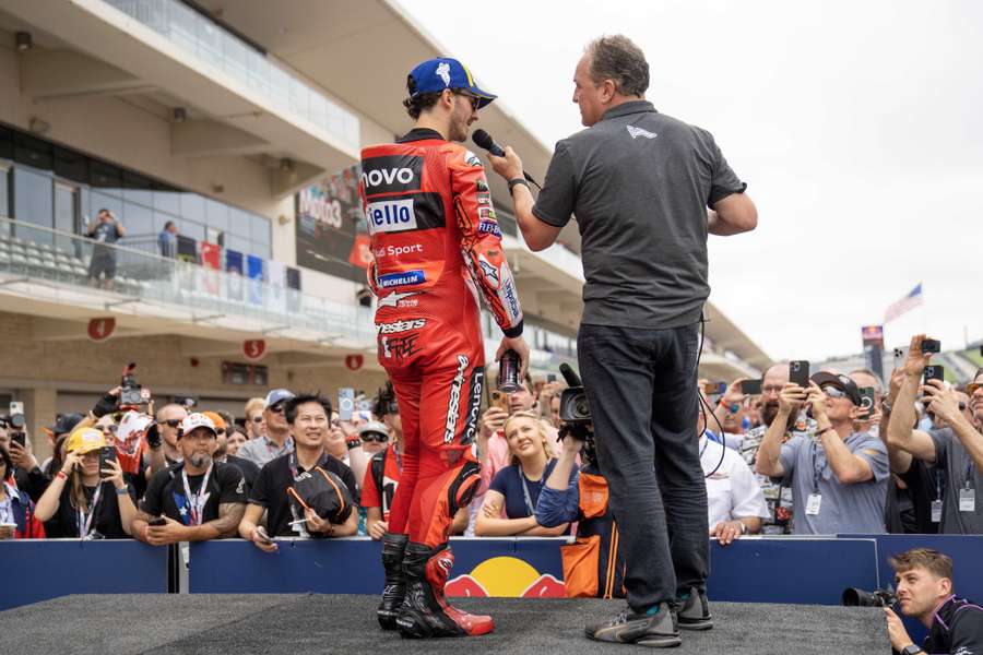 Franceso Bagnaia speaks to the crowd after winning the sprint race