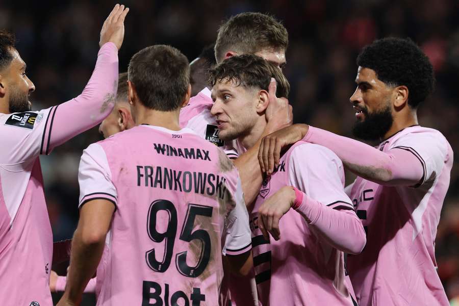 Rennes celebrate a goal against Strasbourg in their striking pink change kit