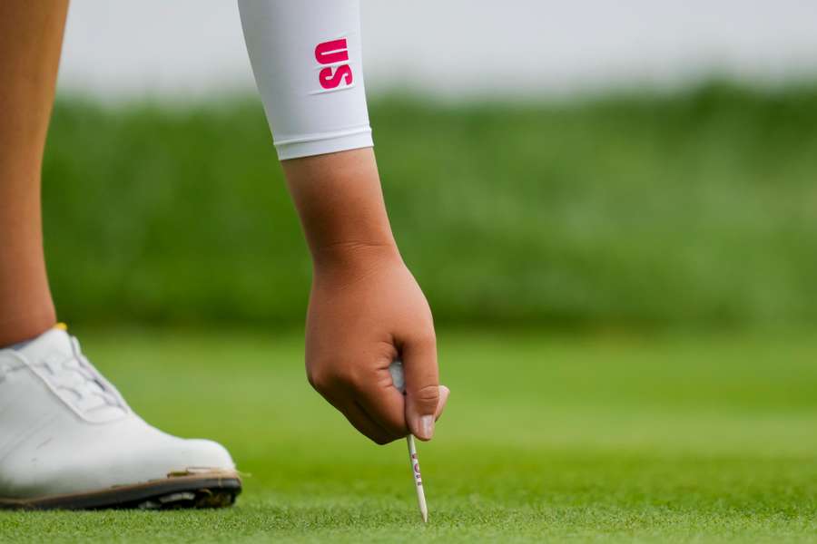 Allisen Corpuz of Team USA places her tee as she prepares to tee from the 15th hole 