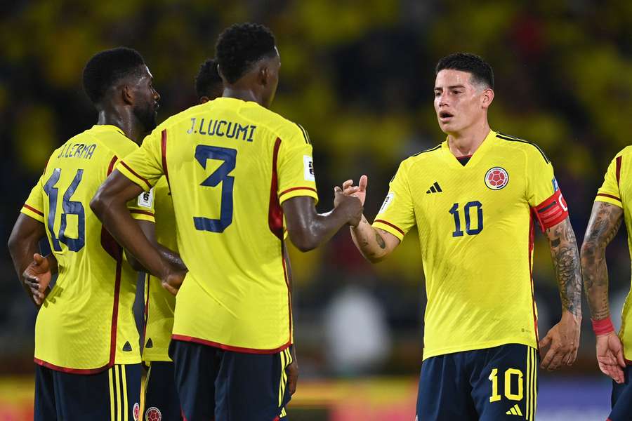 Colombia midfielder James Rodriguez (R) celebrates with Jhon Lucumi (2L) and Jefferson Lerma