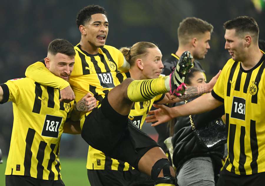 Dortmund's Turkish midfielder Salih Ozcan, Dortmund's English midfielder Jude Bellingham and Dortmund's German defender Niklas Suele celebrate