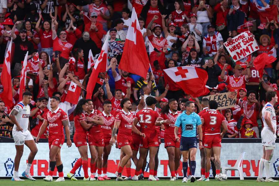 Tonga players celebrate a try against England at the Rugby League World Cup. Tonga players celebrate a try against England at the Rugby League World Cup.