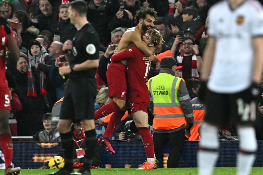 Mohamed Salah celebrates with Liverpool's English midfielder Harvey Elliott
