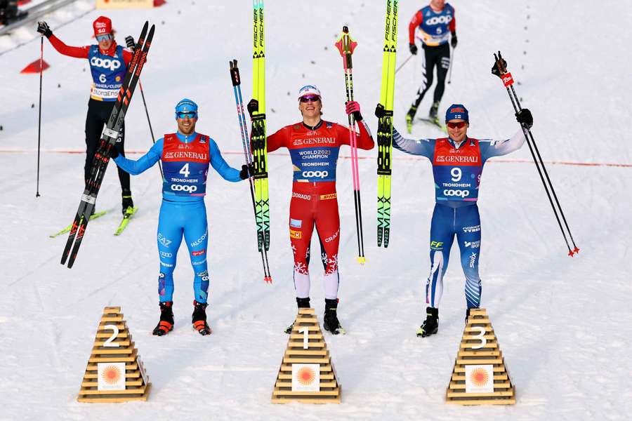 Klaebo (centre) celebrates winning the men's sprint free final