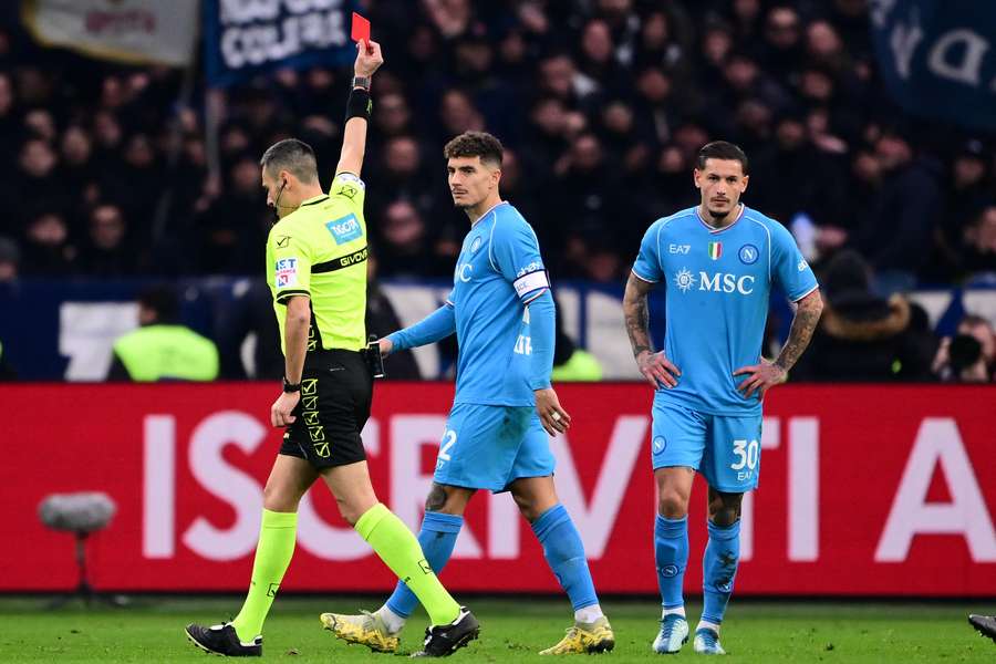 Referee Maurizio Mariani (L) gives a red card to Napoli defender Pasquale Mazzocchi (R) 