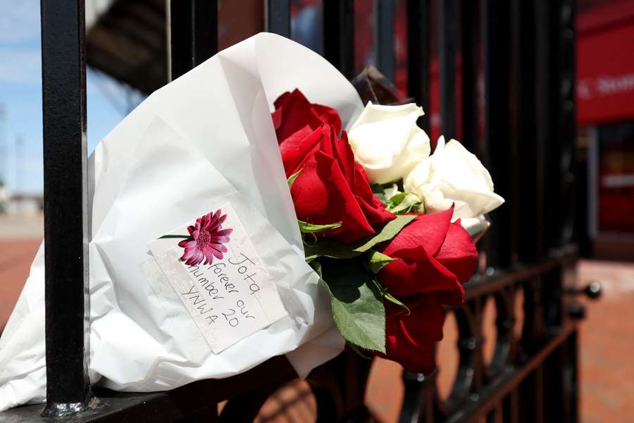 A tribute which reads "Jota forever our number 20 YNWA" on gates on the outside of Anfield
