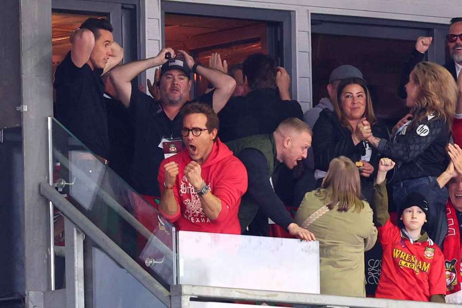 Actors and Wrexham owners Rob McElhenney and Ryan Reynolds celebrate after Wrexham's Sam Smith scores their third goal against Charlton