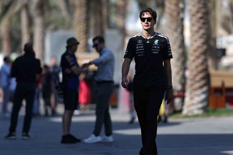 George Russell walks through the Bahrain paddock