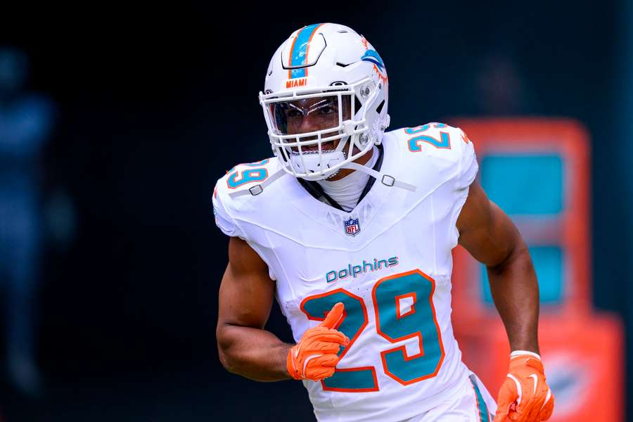 Minkah Fitzpatrick runs on to the field before a game