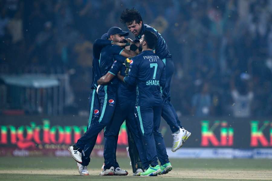 Pakistan's players celebrate their win in the fifth T20 between Pakistan and England at the Gaddafi Cricket Stadium in Lahore.