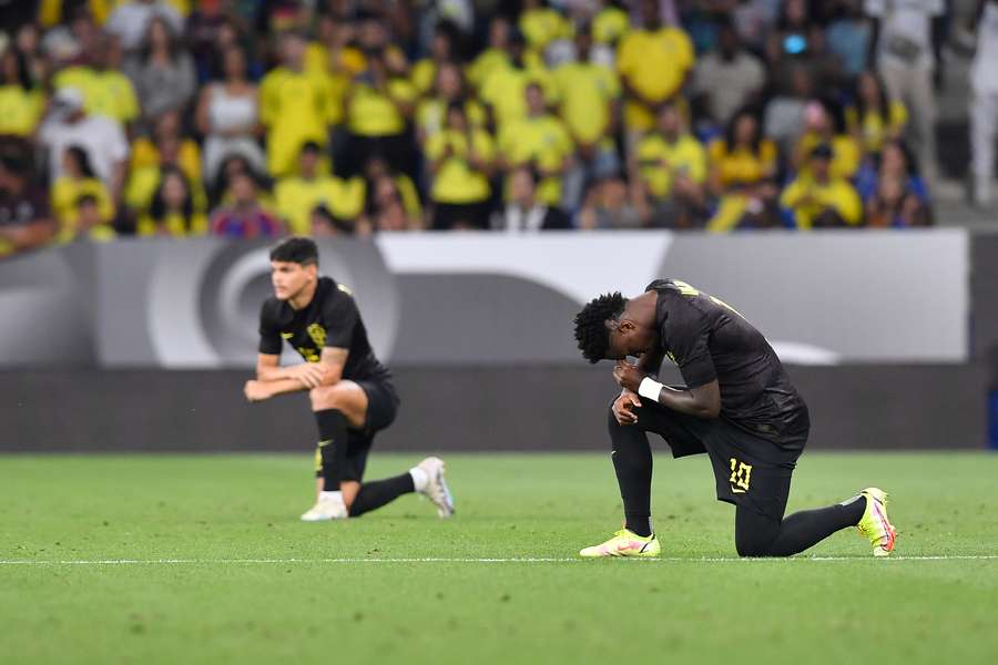 Brazil's forward Vinicius Junior takes a knee before the start of the international friendly football match between Brazil and Guinea
