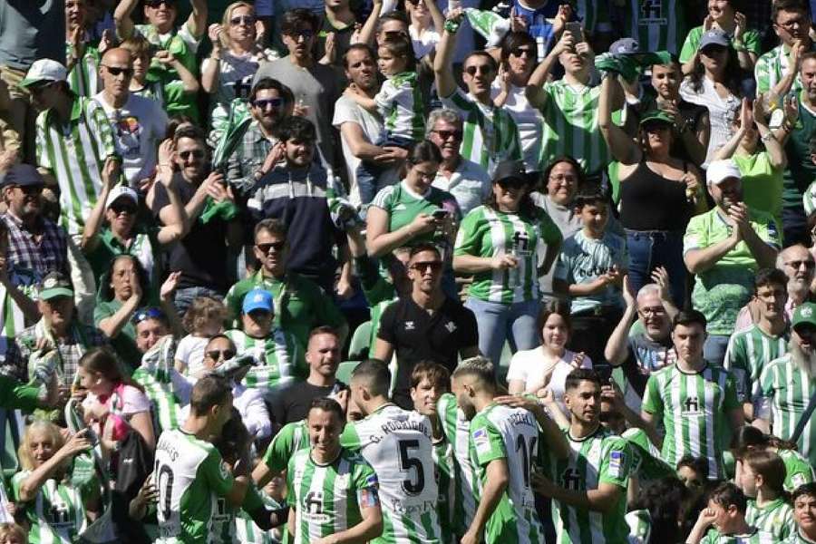 Betis fans and players celebrate their goal