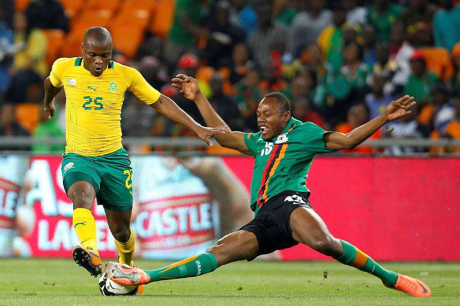 Zambia's Stoppila Sunzu (R) challenges Tokelo Rantie of South Africa in 2012