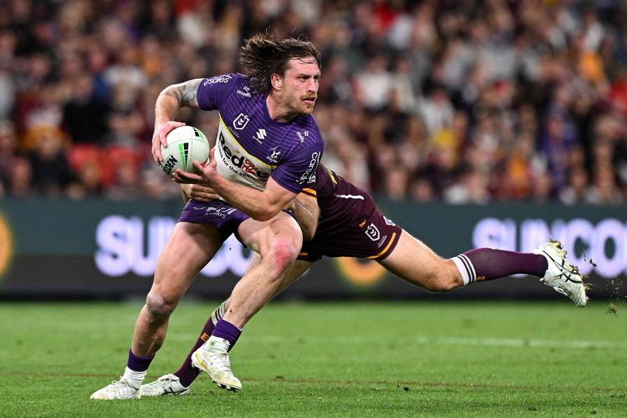 Cameron Munster looks to pass the ball in the Round 27 game against the Broncos at Suncorp Stadium. 