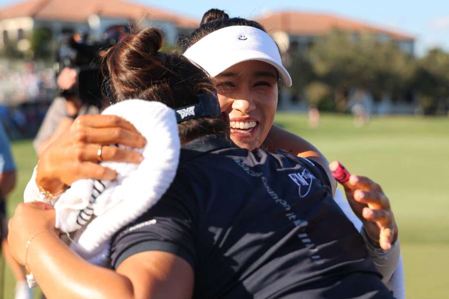 Megan Khang congratulates Amy Yang on her win on the 18th green during the final round of the Tour Championship