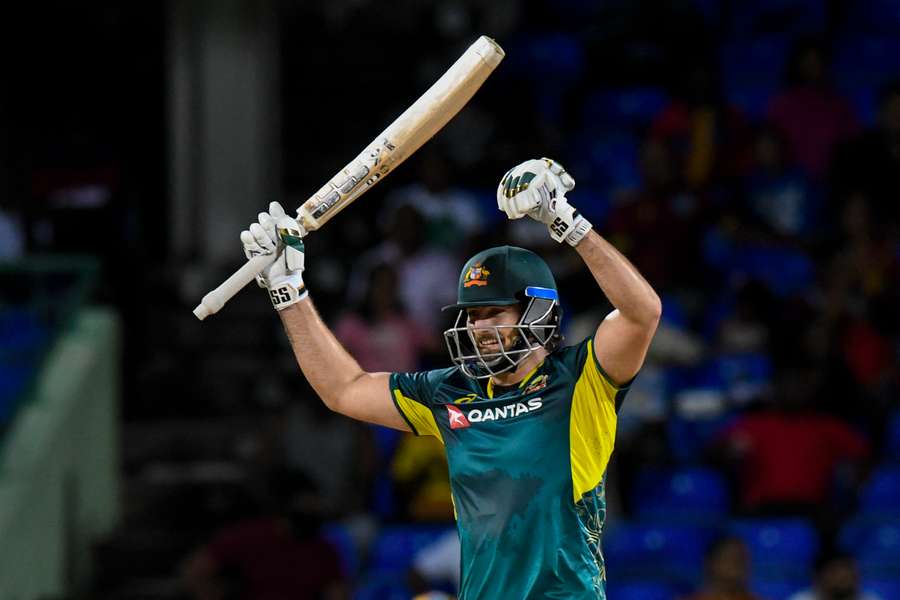 Tim David celebrates the runs that both won the game for Australia and brought up his first T20 century.