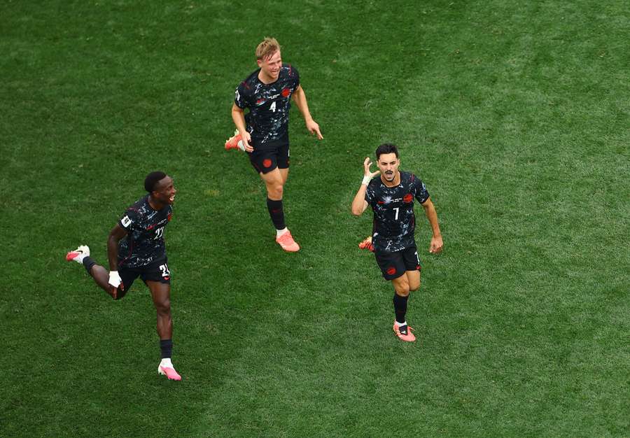 Canada's Stephen Eustaquio (R) celebrates scoring