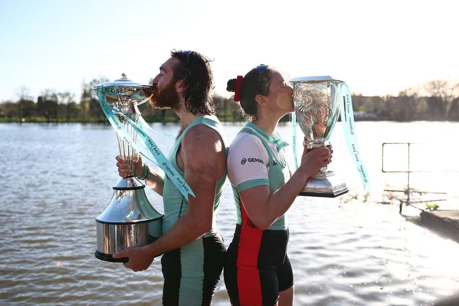 Cambridge University's Sebastian Benzecry and Jenna Armstrong pose with their trophies after winning the 2024 races against Oxford University